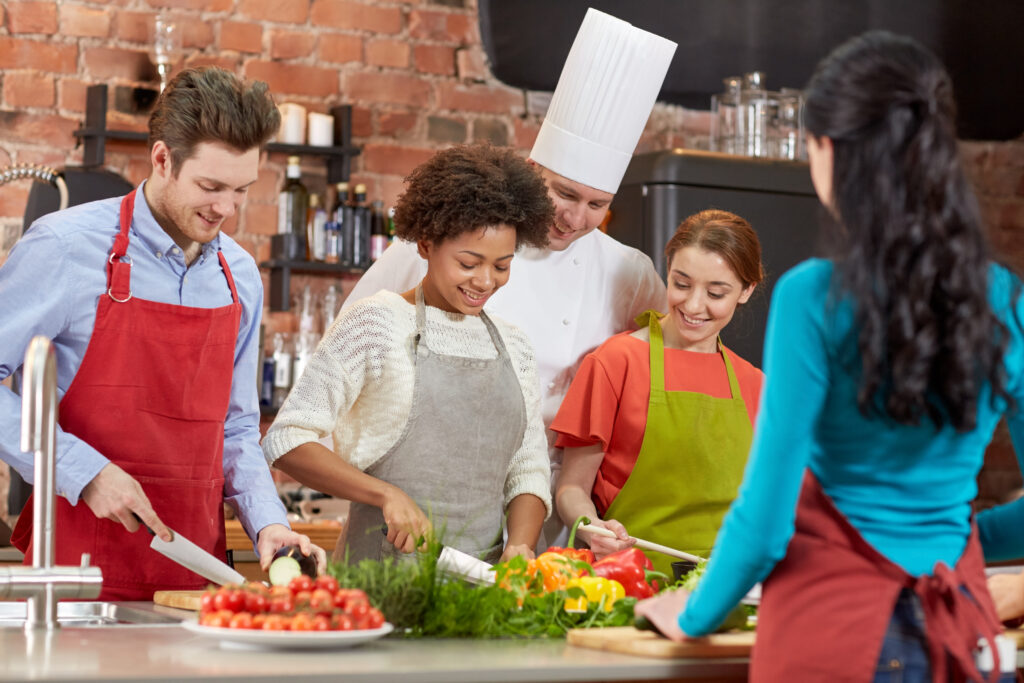 cooking-class-culinary-food-people-concept-happy-group-friends-male-chef-cook-cooking-kitchen