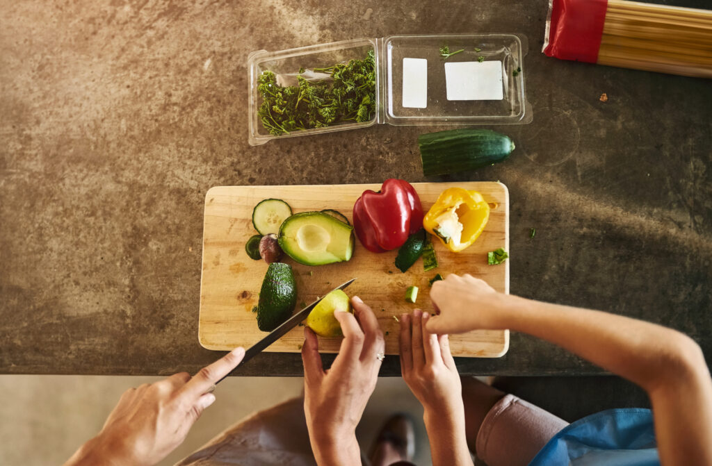 food-nutrition-diet-with-hands-chopping-ingredients-salad-kitchen-counter-dinner-healthy-meal-prep-vegetables-with-avocado-pepper-pasta-clean-eating-family-home