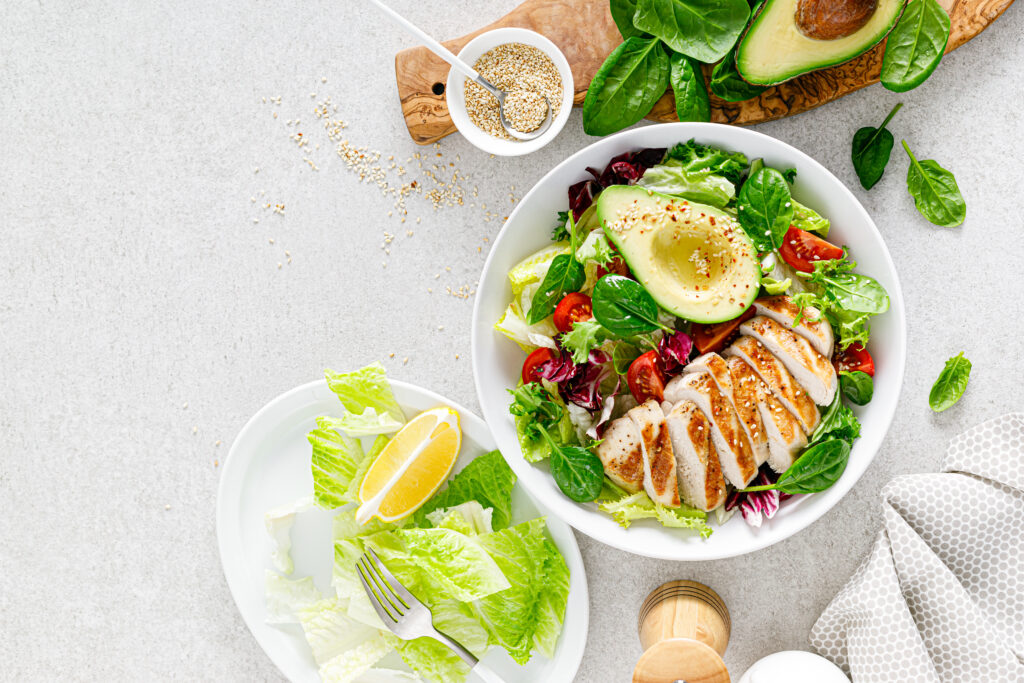grilled-chicken-meat-fresh-vegetable-salad-tomato-avocado-lettuce-spinach-healthy-detox-food-concept-ketogenic-diet-buddha-bowl-dish-white-background-top-view